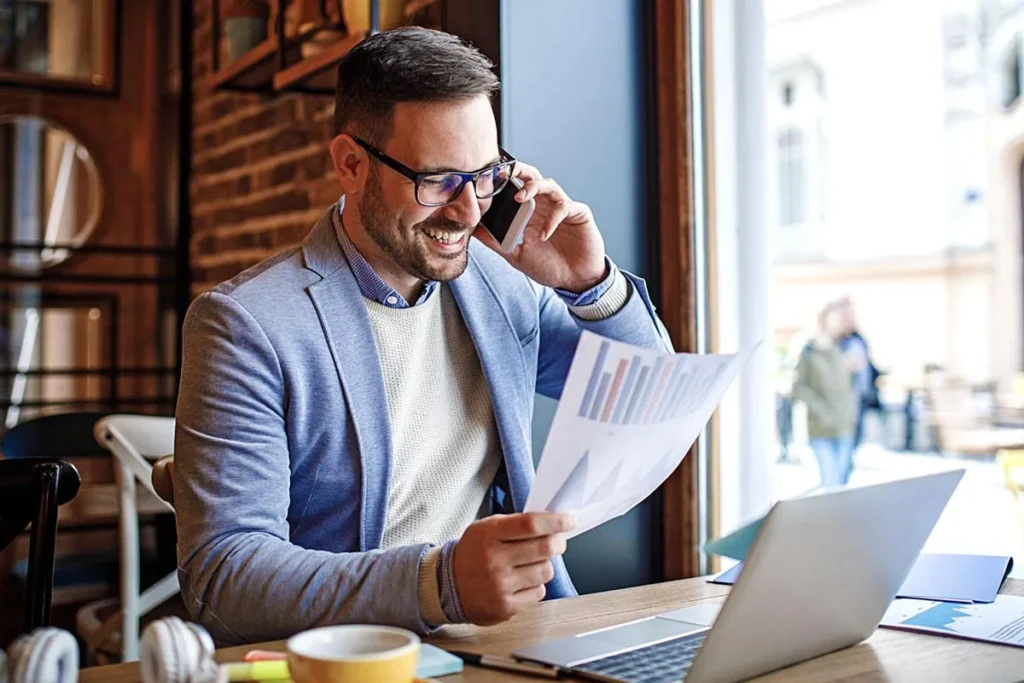 An advertising manager sitting in a cafe looking at a data report