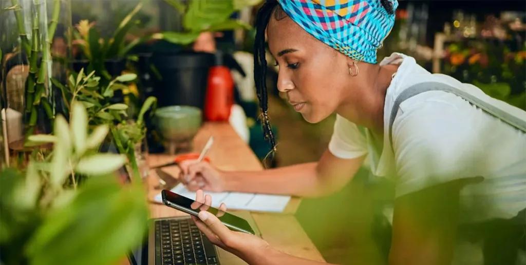 Florist using her phone to create an online ad for her small business