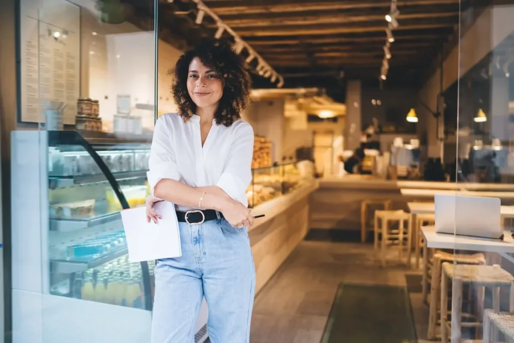 Cafe owner standing outside her shop