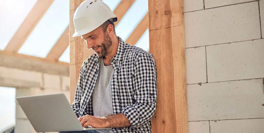 Roofing marketing: roofer working on his company's roofing advertisement