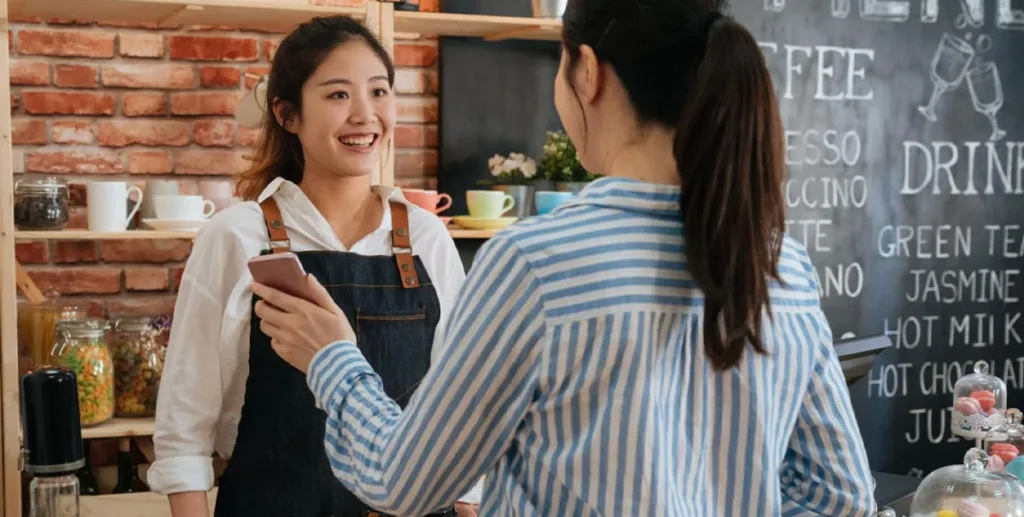 Coffee shop owner serving a customer