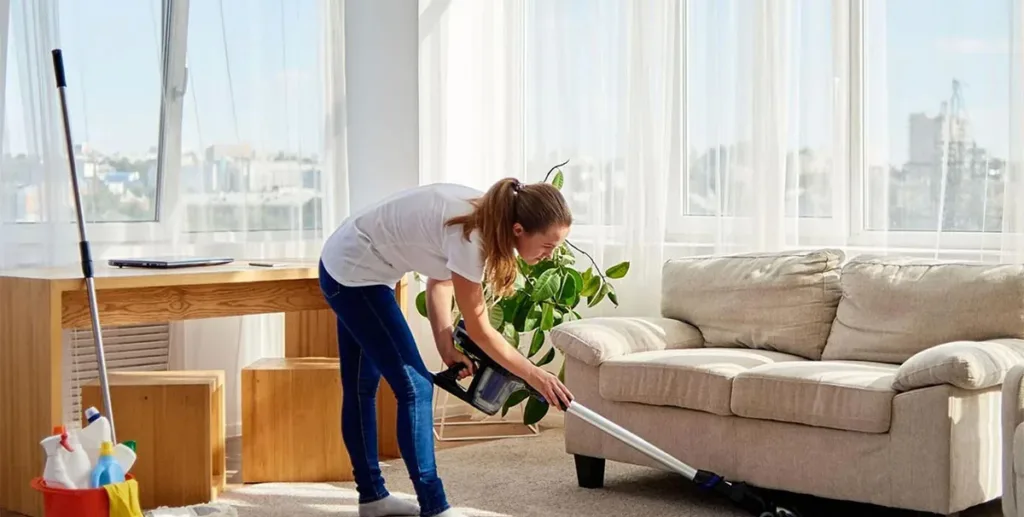 Advertise cleaning services: cleaner vacuuming apartment 