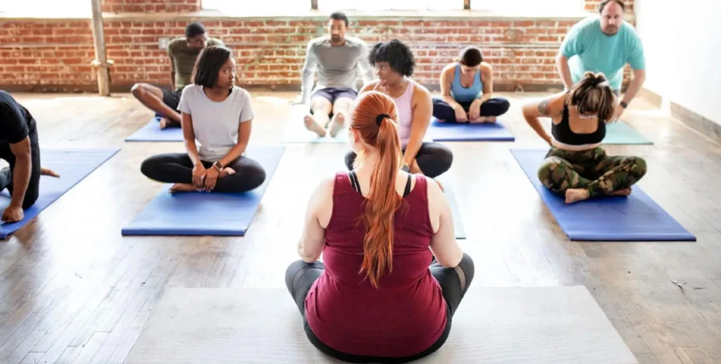 Yoga marketing ideas: Yoga teacher conducting a class