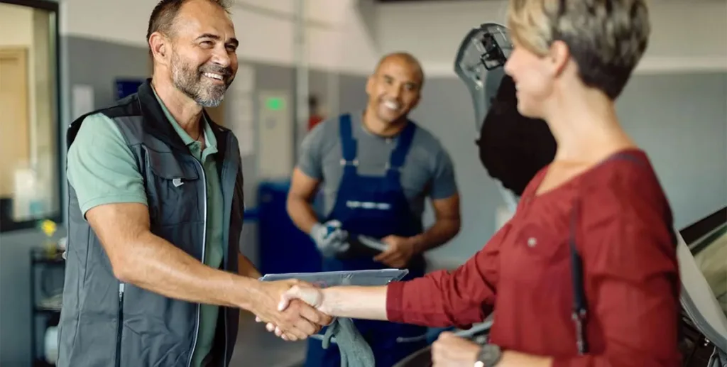 Business owner shaking hands with customer