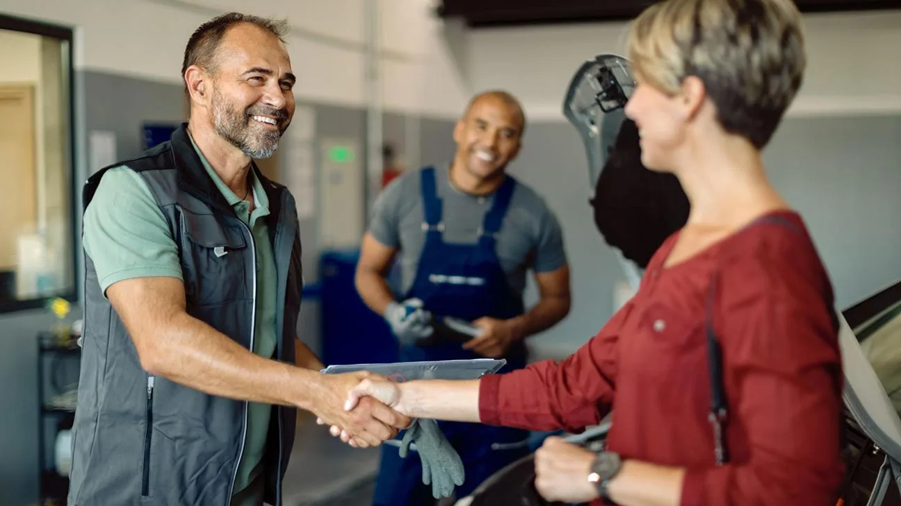 Business owner shaking hands with customer