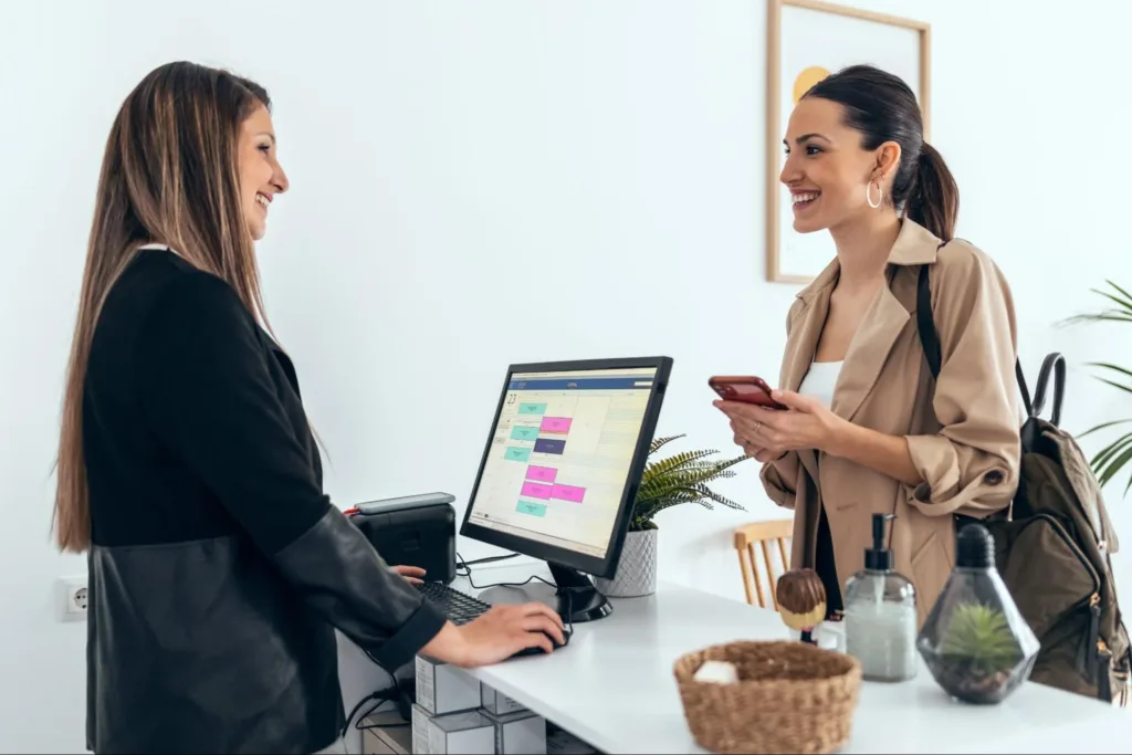 Woman booking an appointment at a front desk