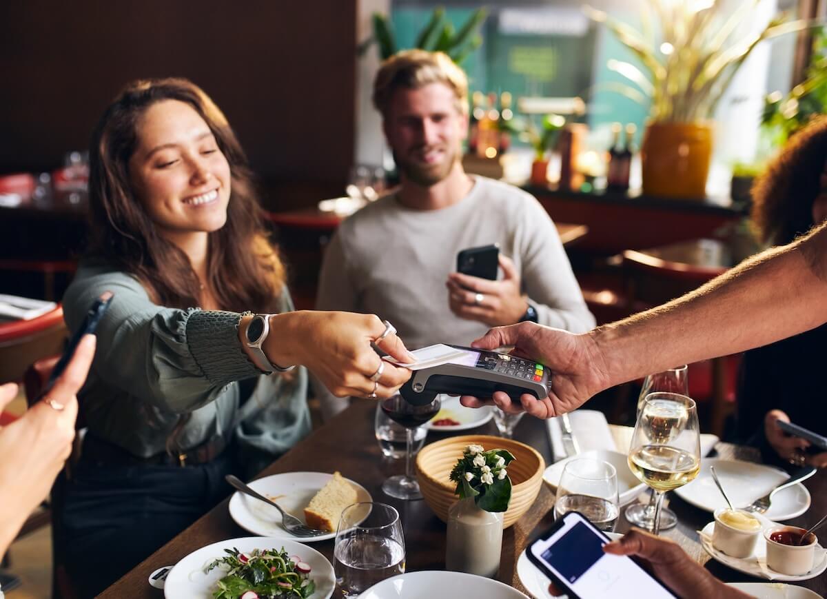 Table management: woman paying using her card