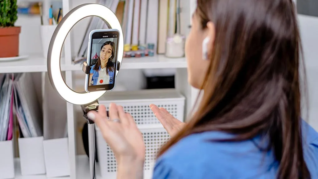 Social media influencer recording a video using her phone