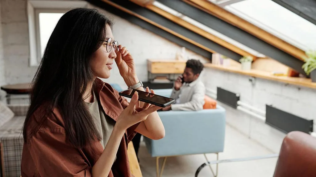 Marketing professional in office using voice search on her phone