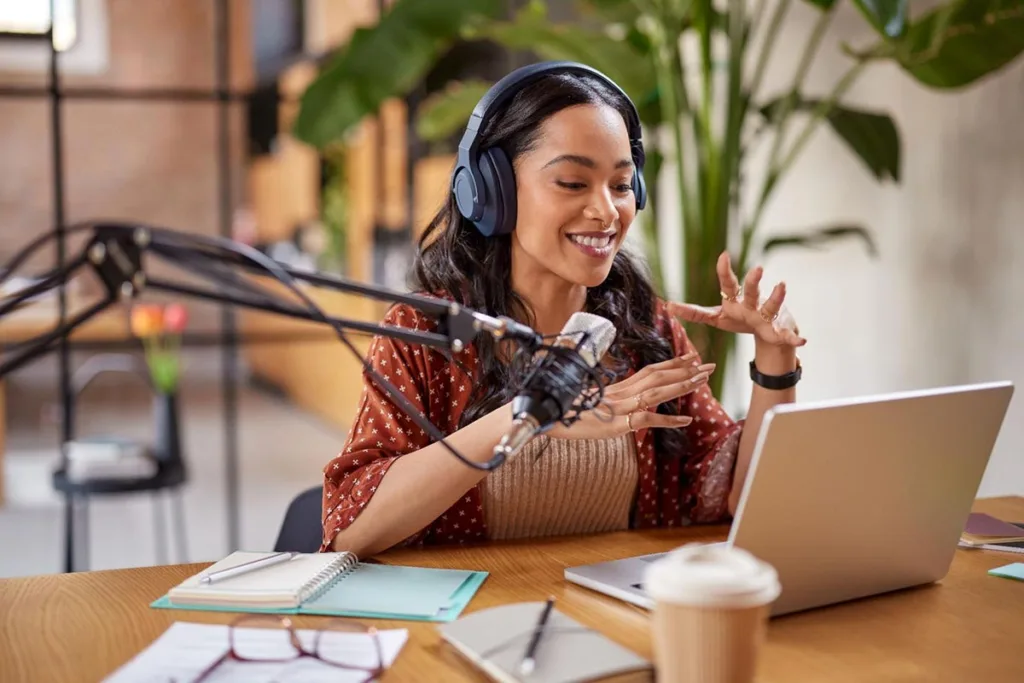 A businesswoman recording a podcast to help potential customers discover her business