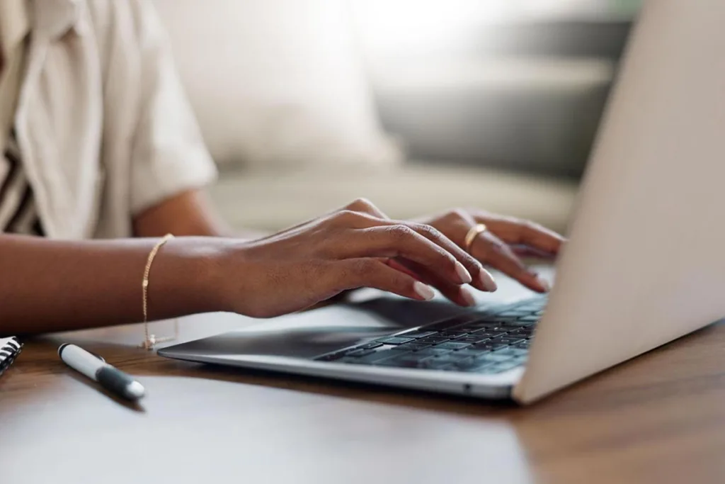 Close-up of a marketing manager using a laptop