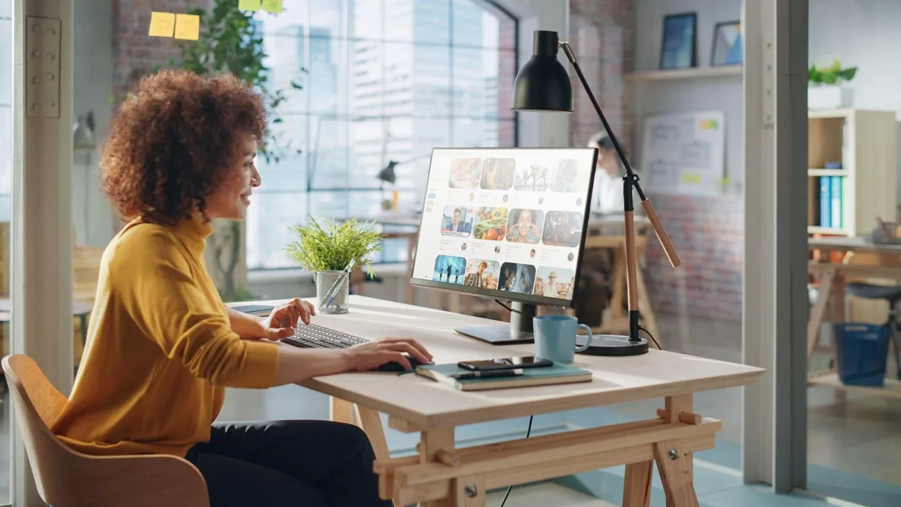 Social media for small business: marketing professional working on a laptop in a modern office setting