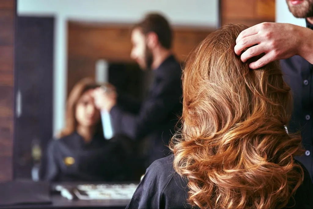 A woman getting her hair styled in a local hair salon