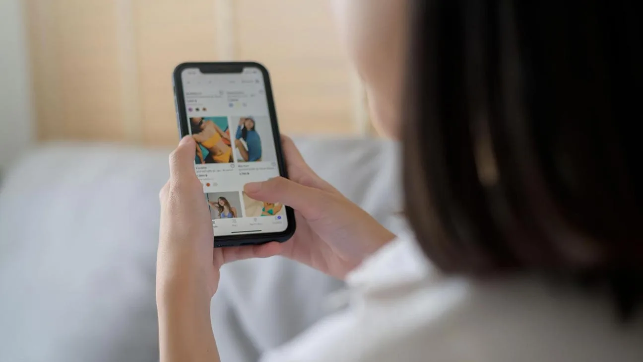 Retargeting ads: woman using smartphone to shop online while browsing products