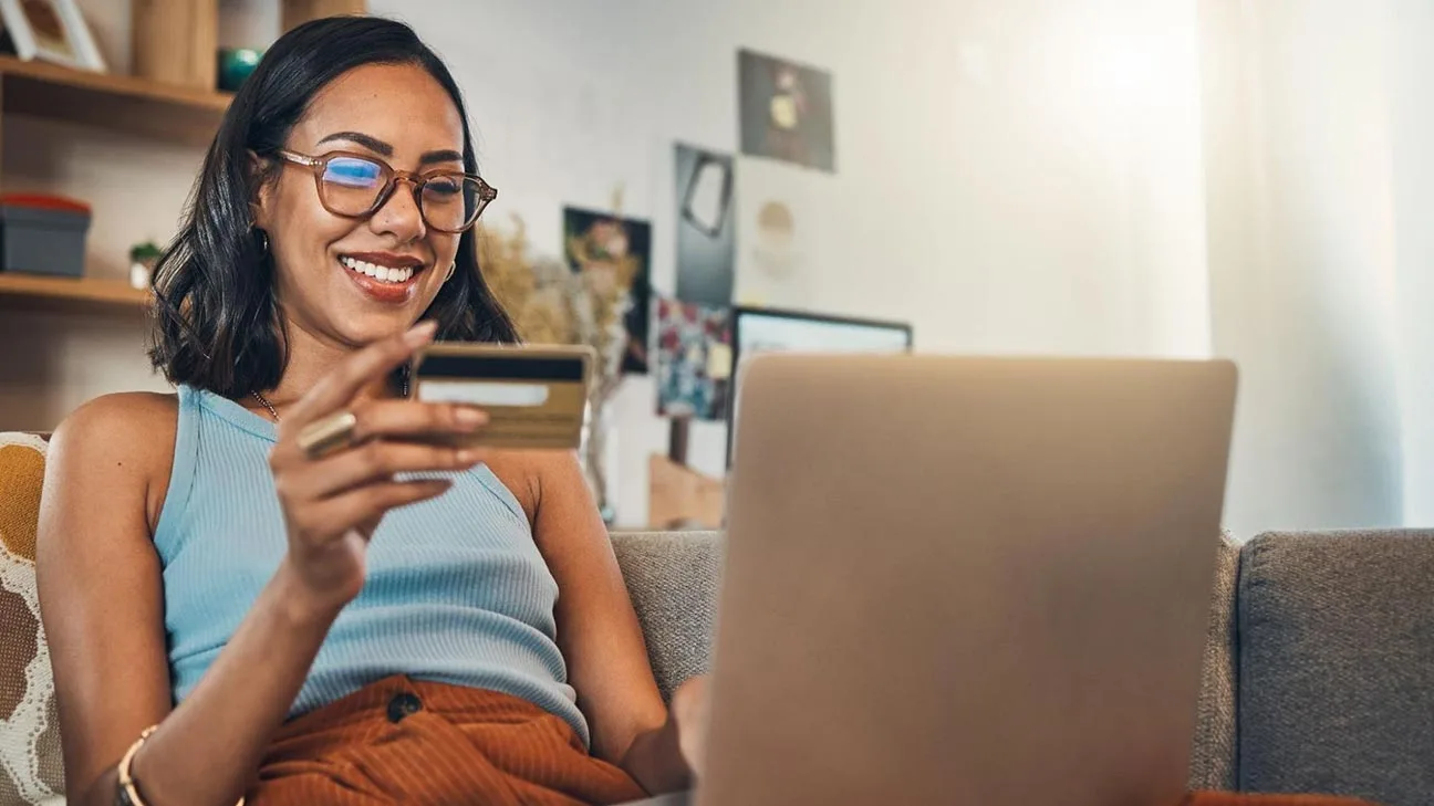 Conversion tracking: woman making an online payment using her bank card on a laptop