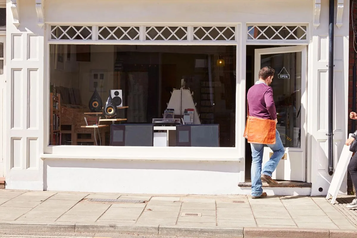 Image of a man entering a local street shop