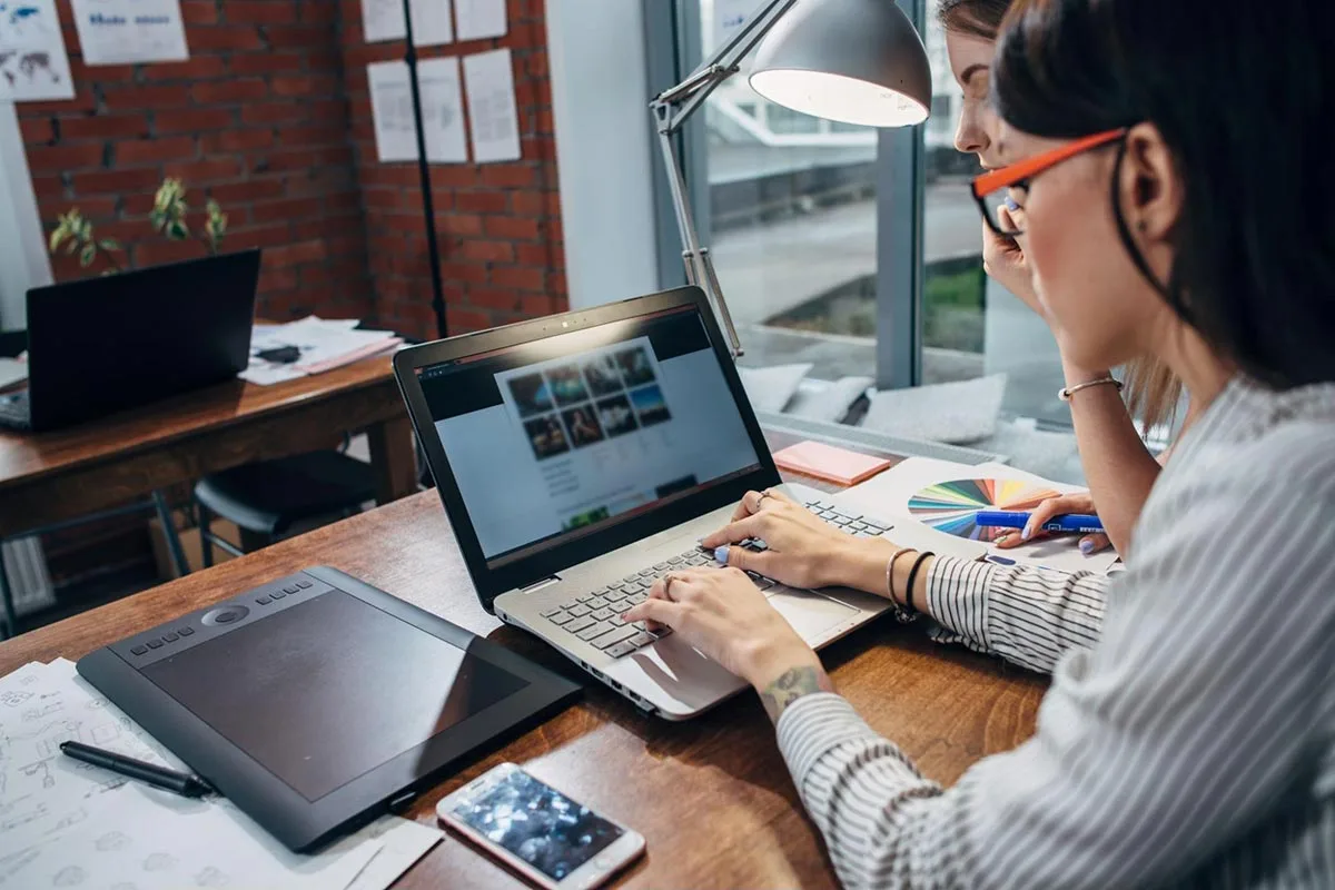 A marketing professional working on a laptop managing retargeting ads