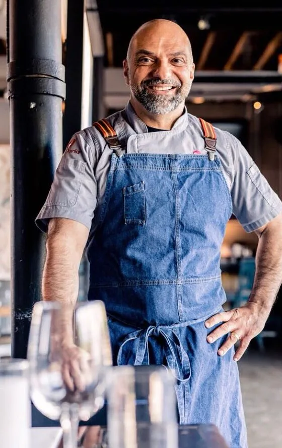 Photo of Chef Rocco Carulli posing in the kitchen.