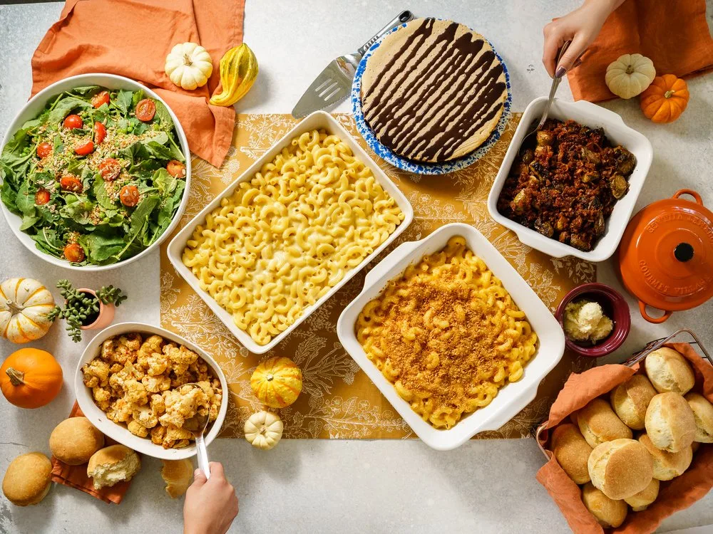 Photo of Homeroom holiday platters with multiple mac and cheese dishes, salads, bread, and more from Homeroom on Yelp