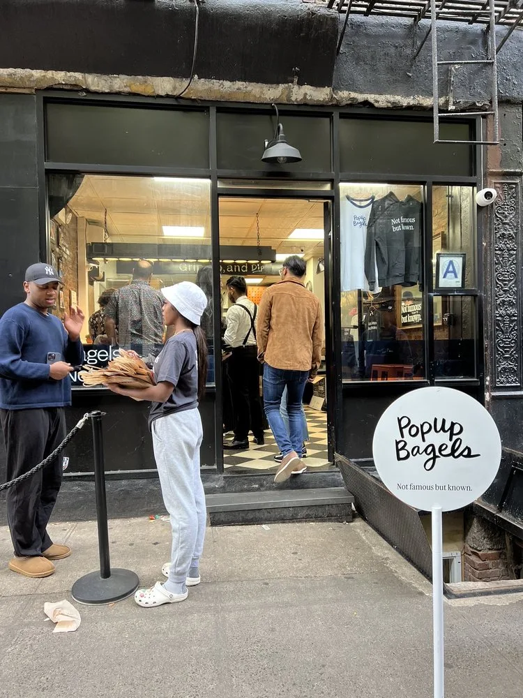 Photo of a PopUp Bagels employee taking orders outside from Yelp user Summer O.