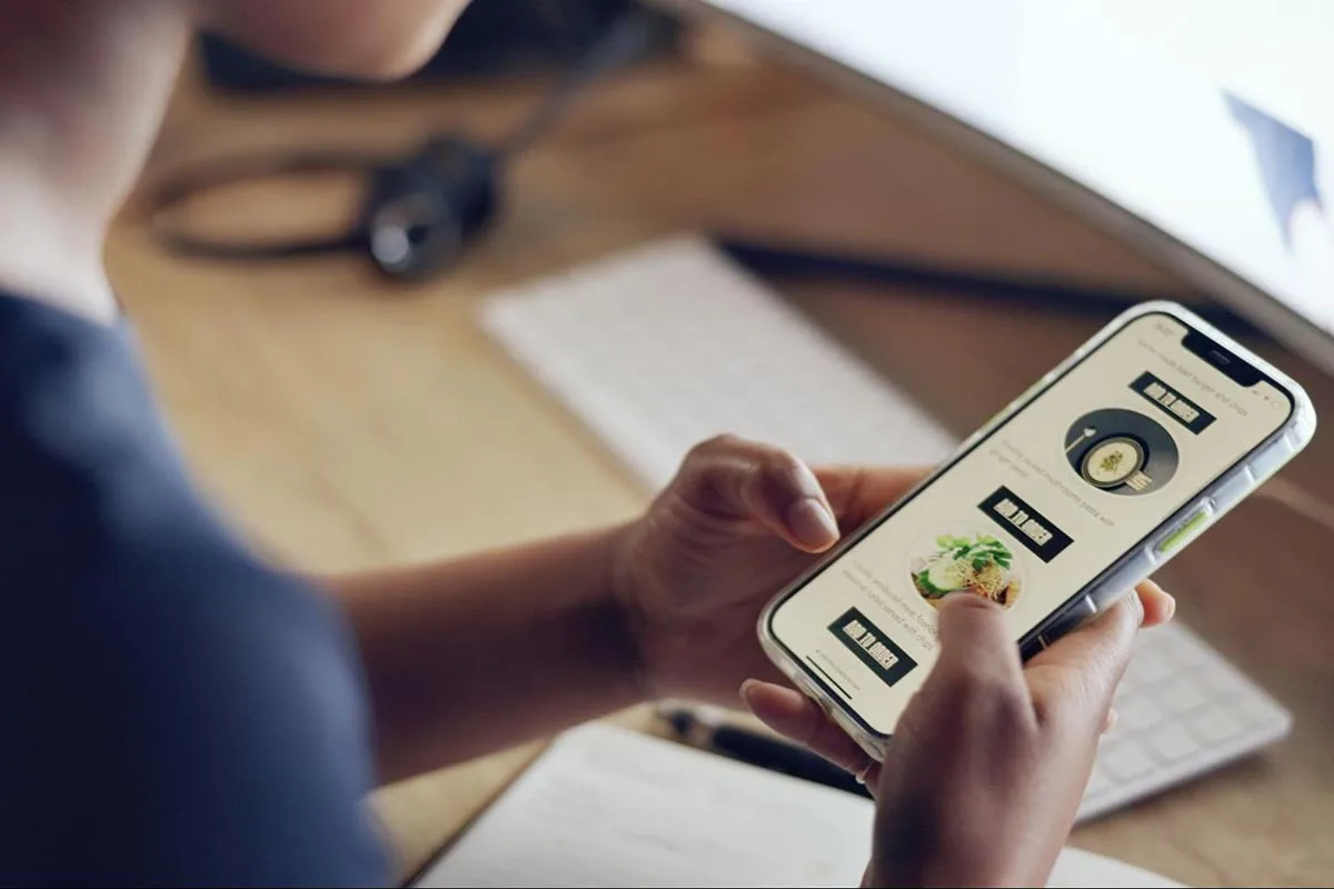 A man browsing a mobile-friendly responsive website on his smartphone