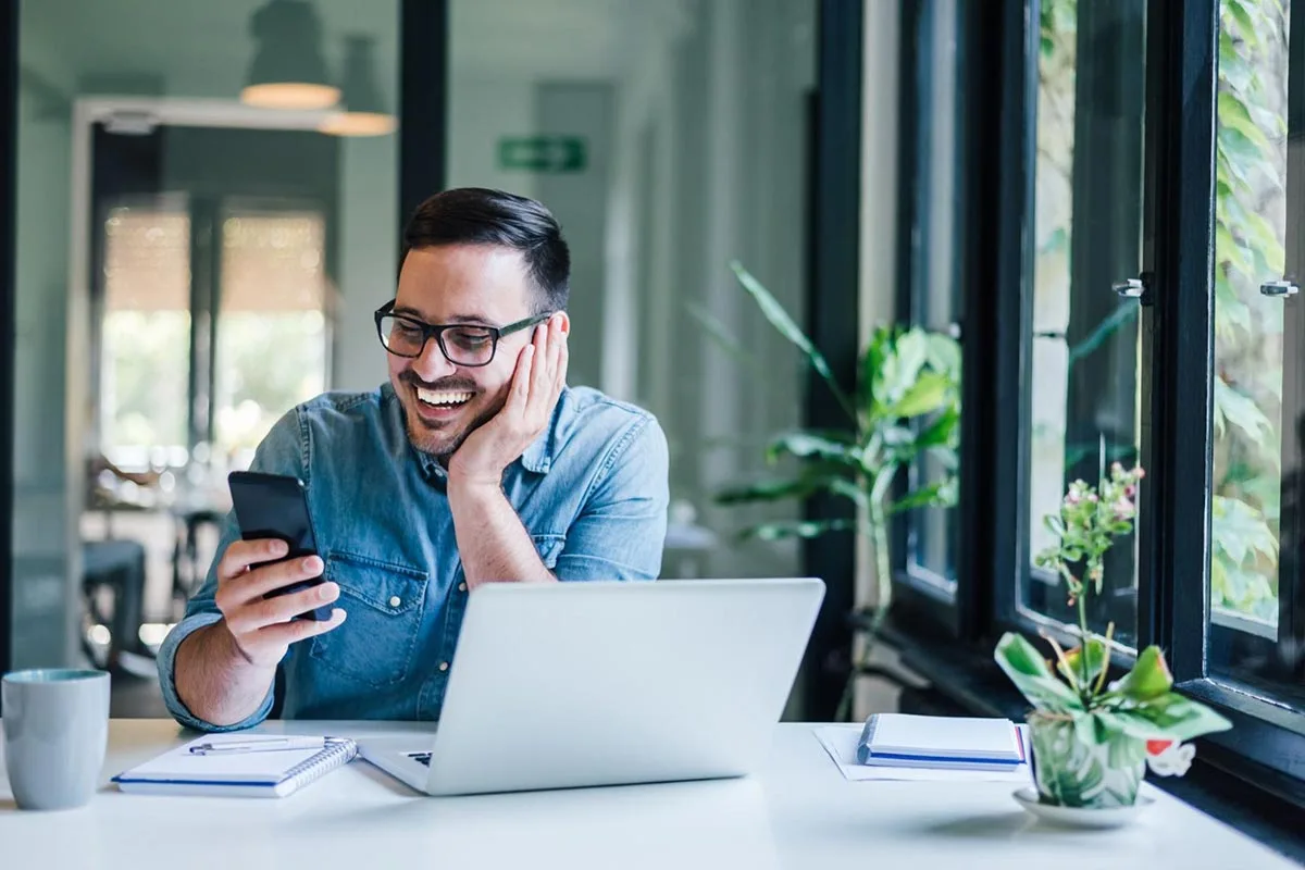 A marketing manager using phone at desk