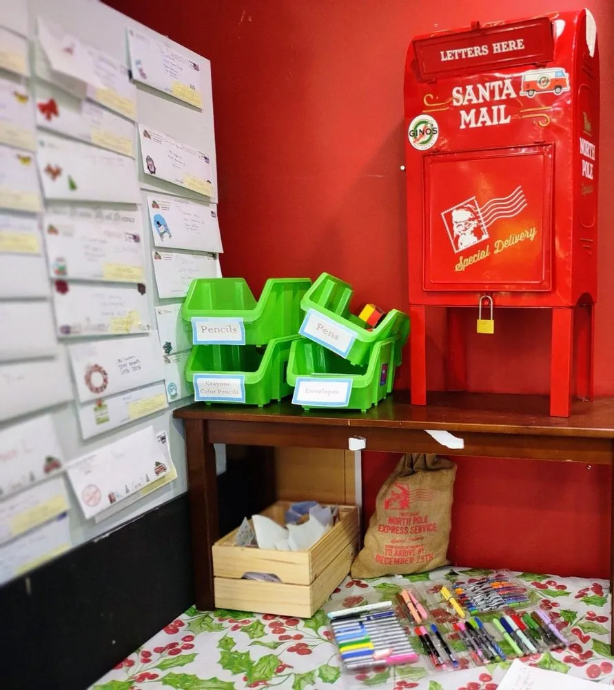 Santa's mailbox area with letters posted on the wall