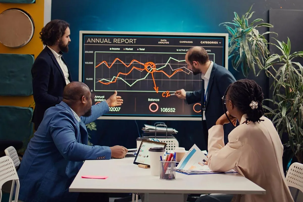 Group of marketing executives discussing the annual report during a meeting 