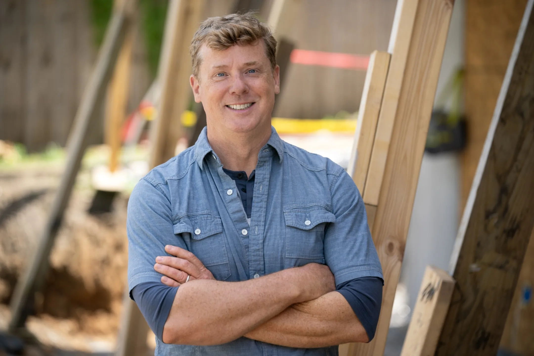Kevin O'Connor smiling in front of a construction site