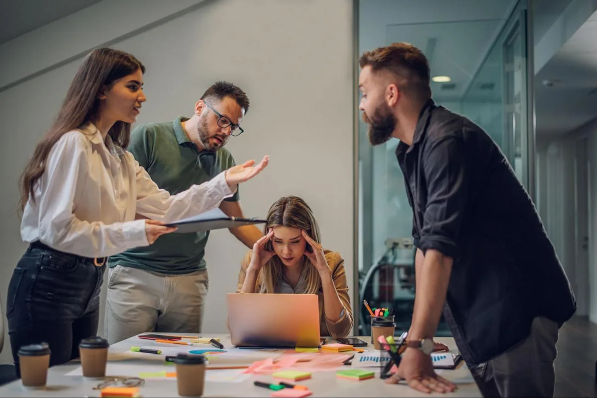 A group of professionals engaged in a collaboration marketing team meeting.