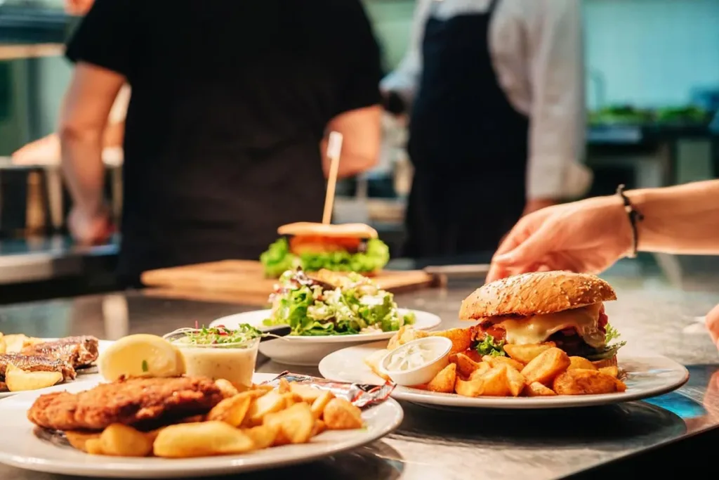 Burger and fries served on a plate ready to eat.