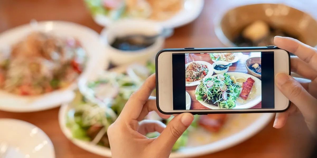 Customer taking a picture of her food