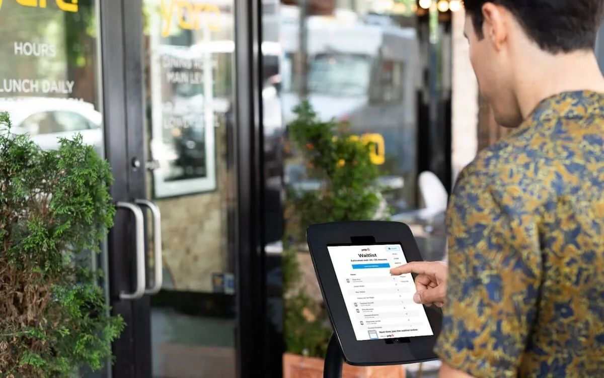 Restaurant kiosk: customer using a self-service kiosk