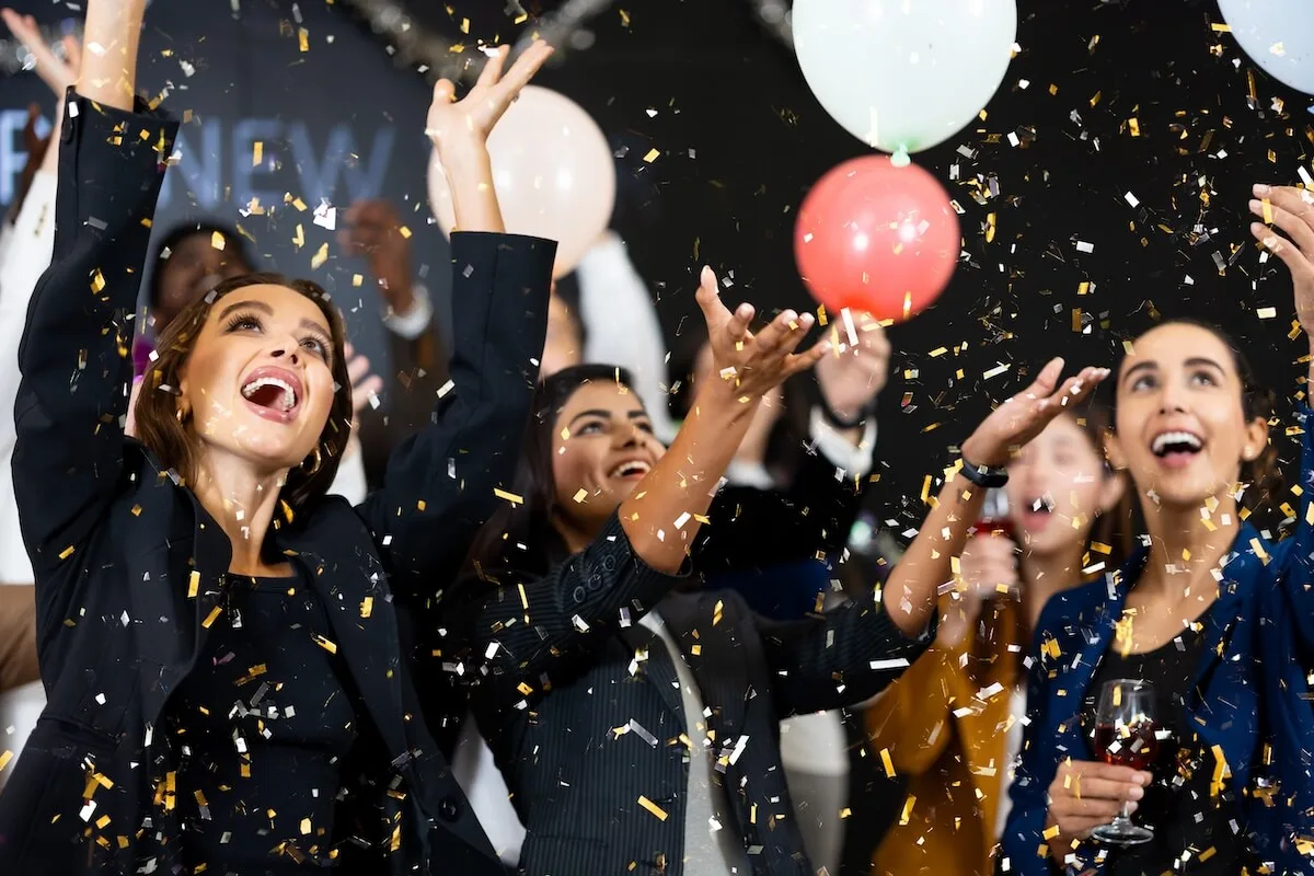 How to attract customers in restaurant: employees throwing confetti and balloons up into the air