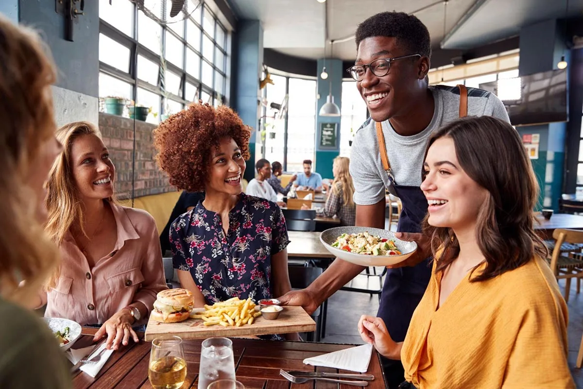 Group of friends enjoying a meal together at a restaurant.