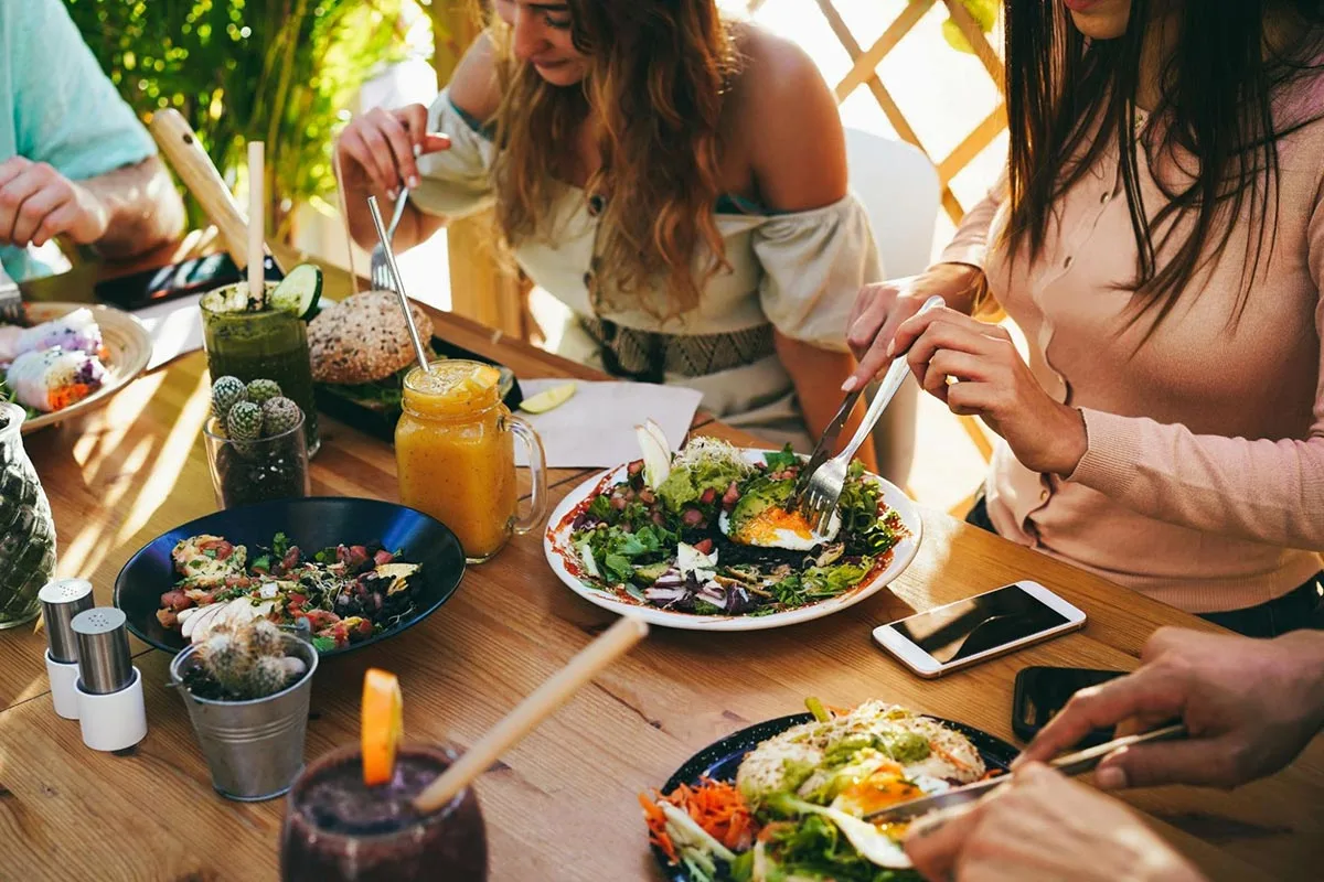 Group of friends having lunch together at a restaurant.