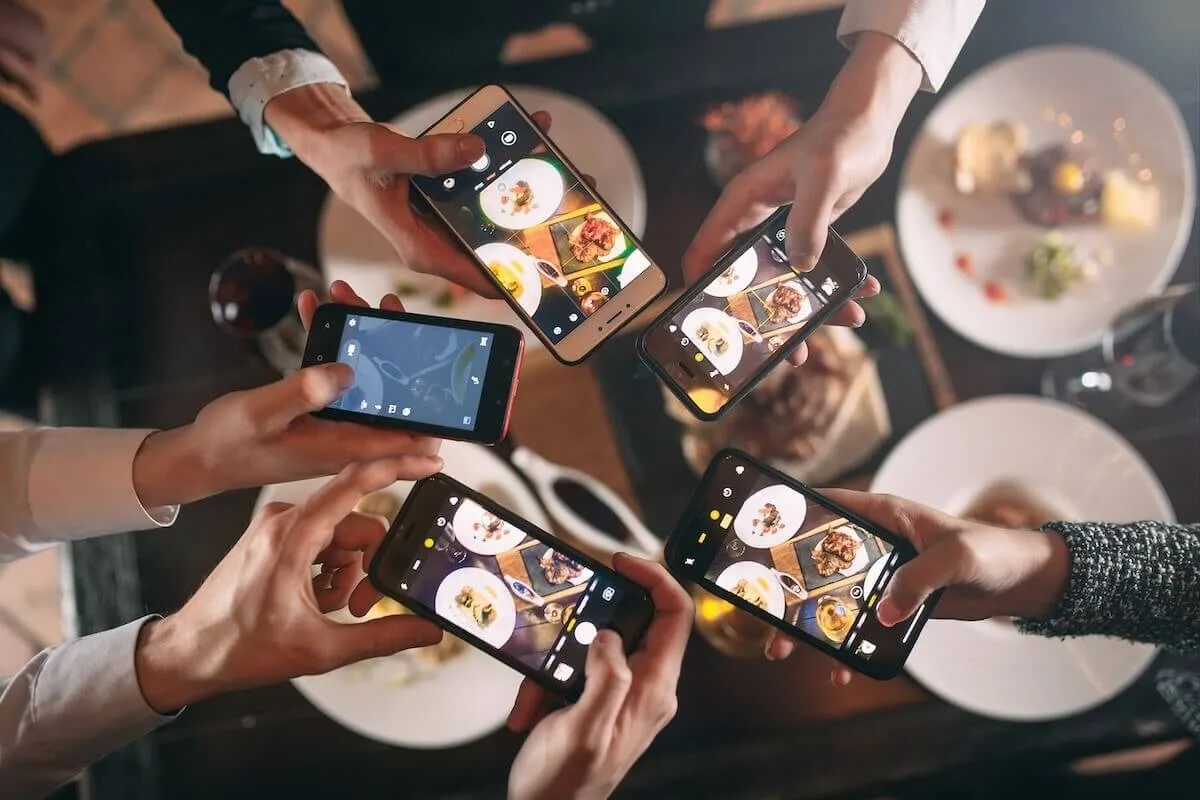 Group of friends taking photos of their food