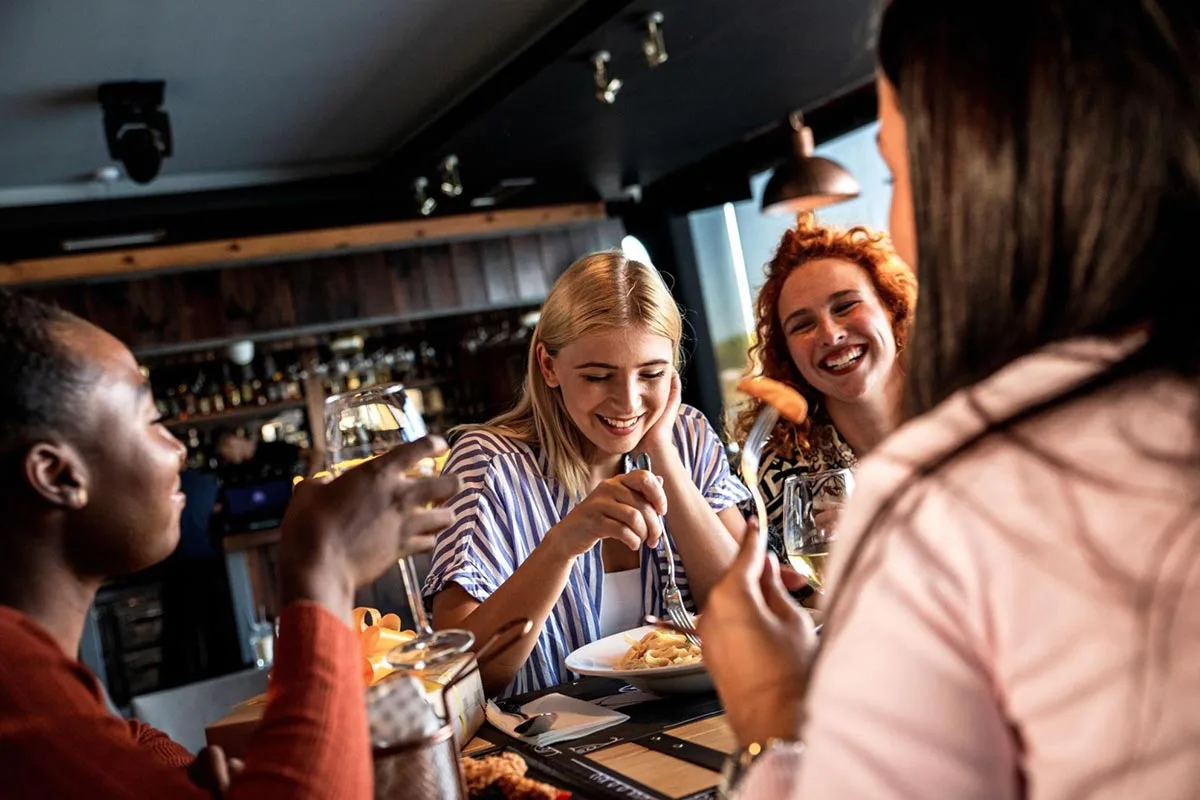 Group of girlfriends enjoying lunch together at a restaurant.