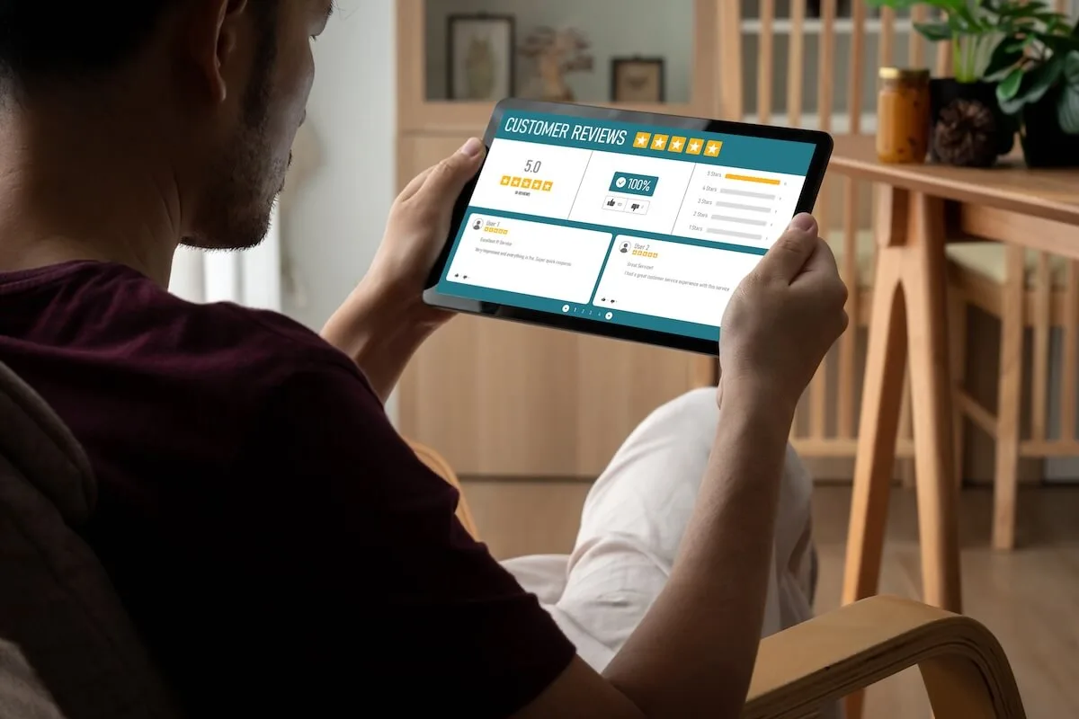 Man using his tablet to give a review