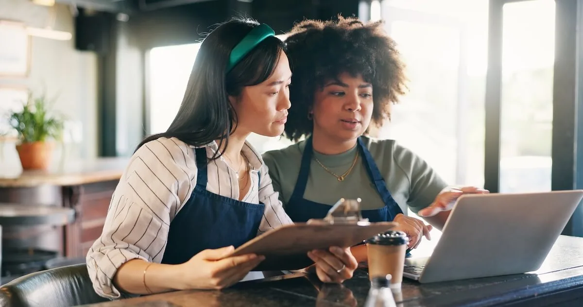 Restaurant marketing software: restaurant employees looking at a laptop