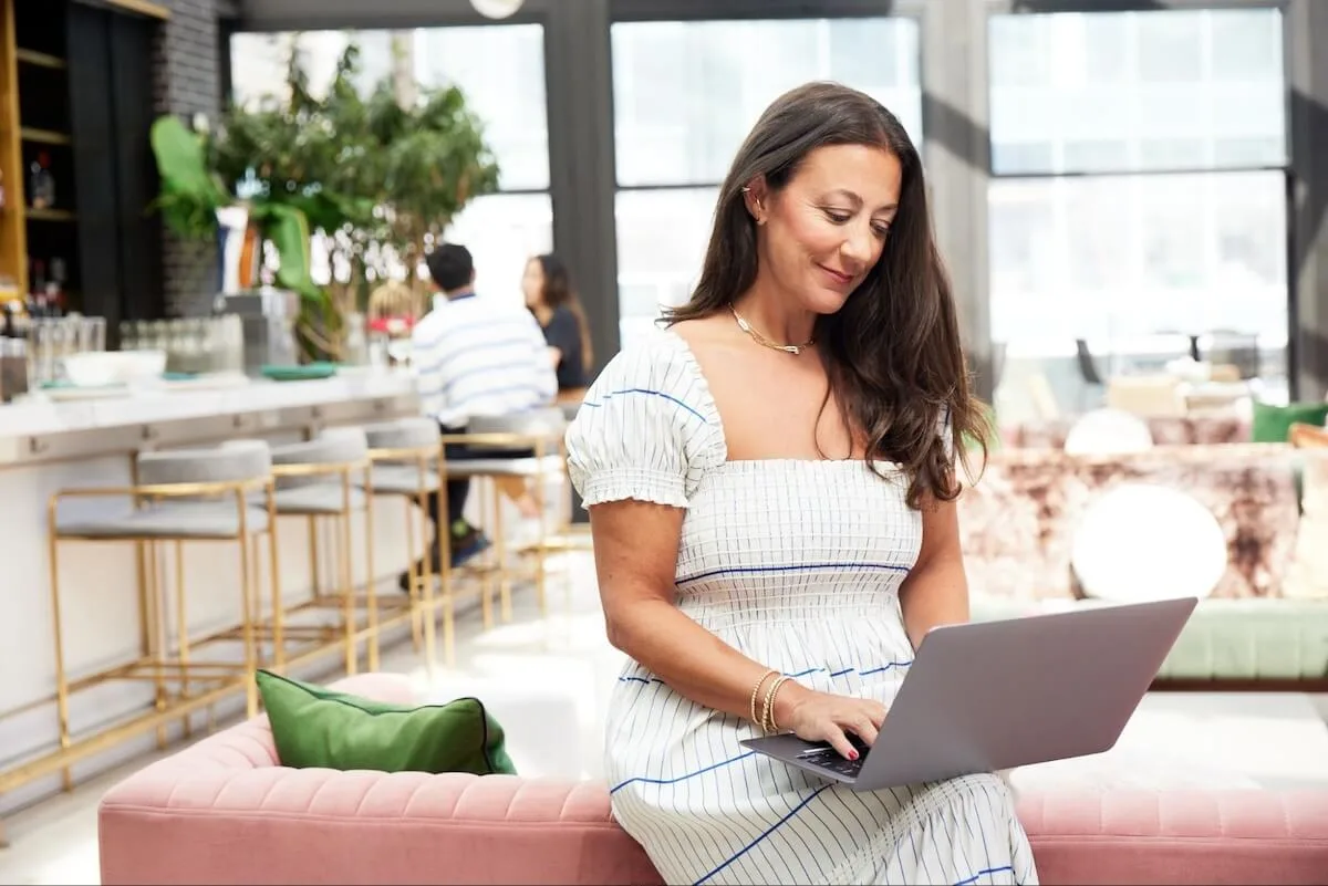 Restaurant manager using a laptop