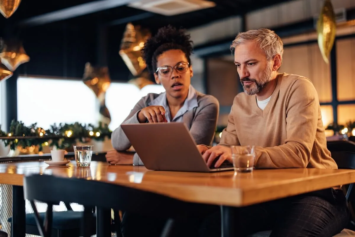 Restaurant marketing software: restaurant managers looking at a laptop