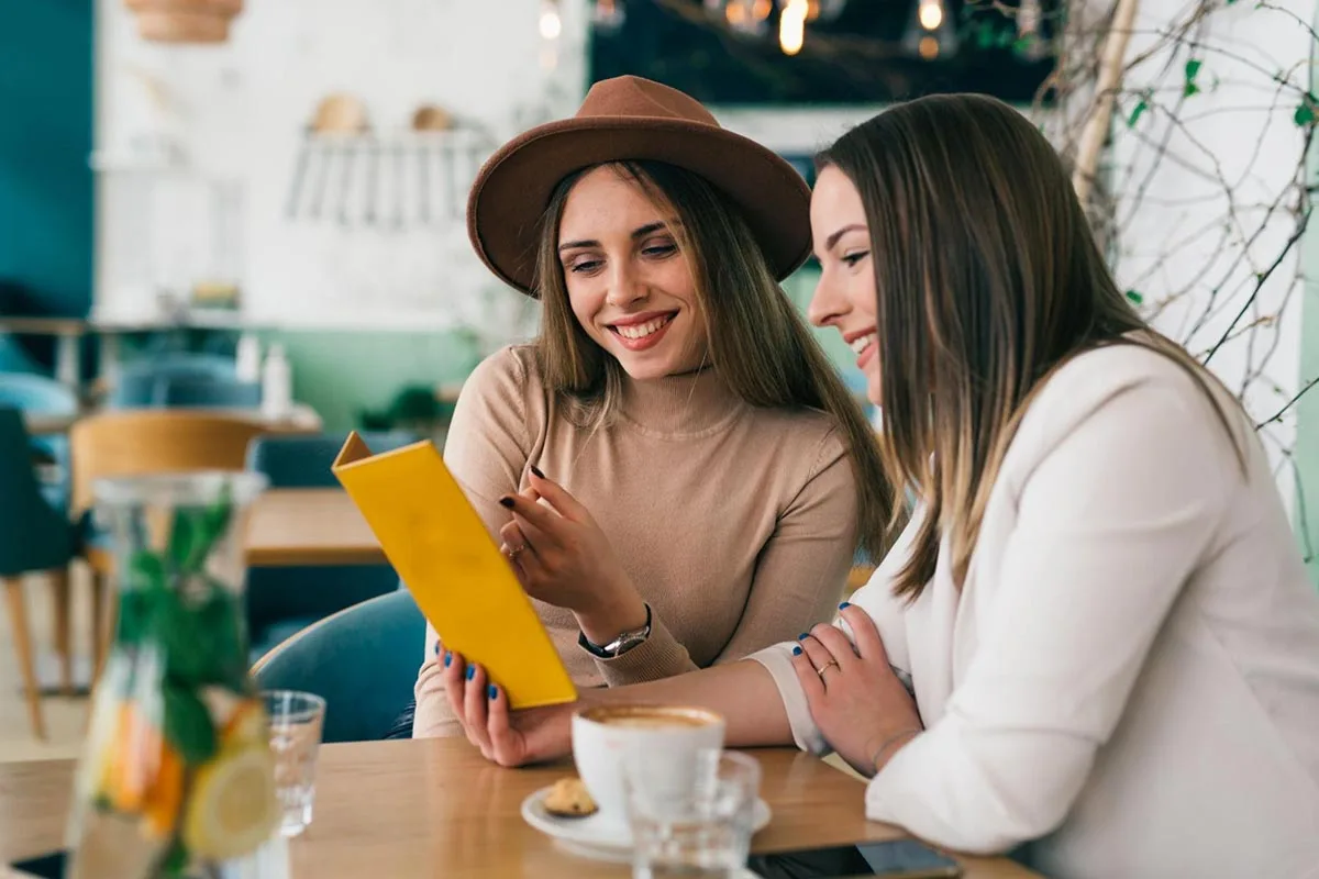 Two friends having brunch together at a cozy restaurant.