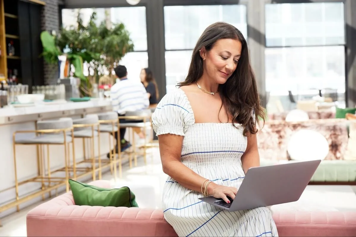 Woman using a laptop at a restaurant