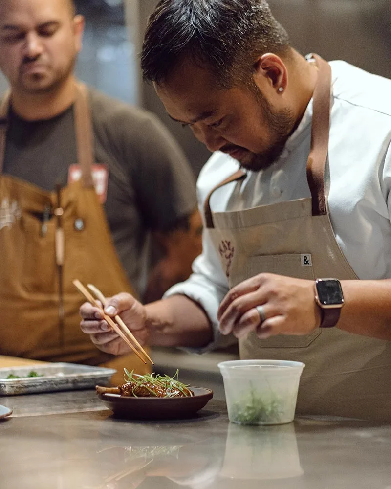 Photo of Kaya Executive Chef Lordfer Lalicon placing the finishing touches on a dish from Kaya.
