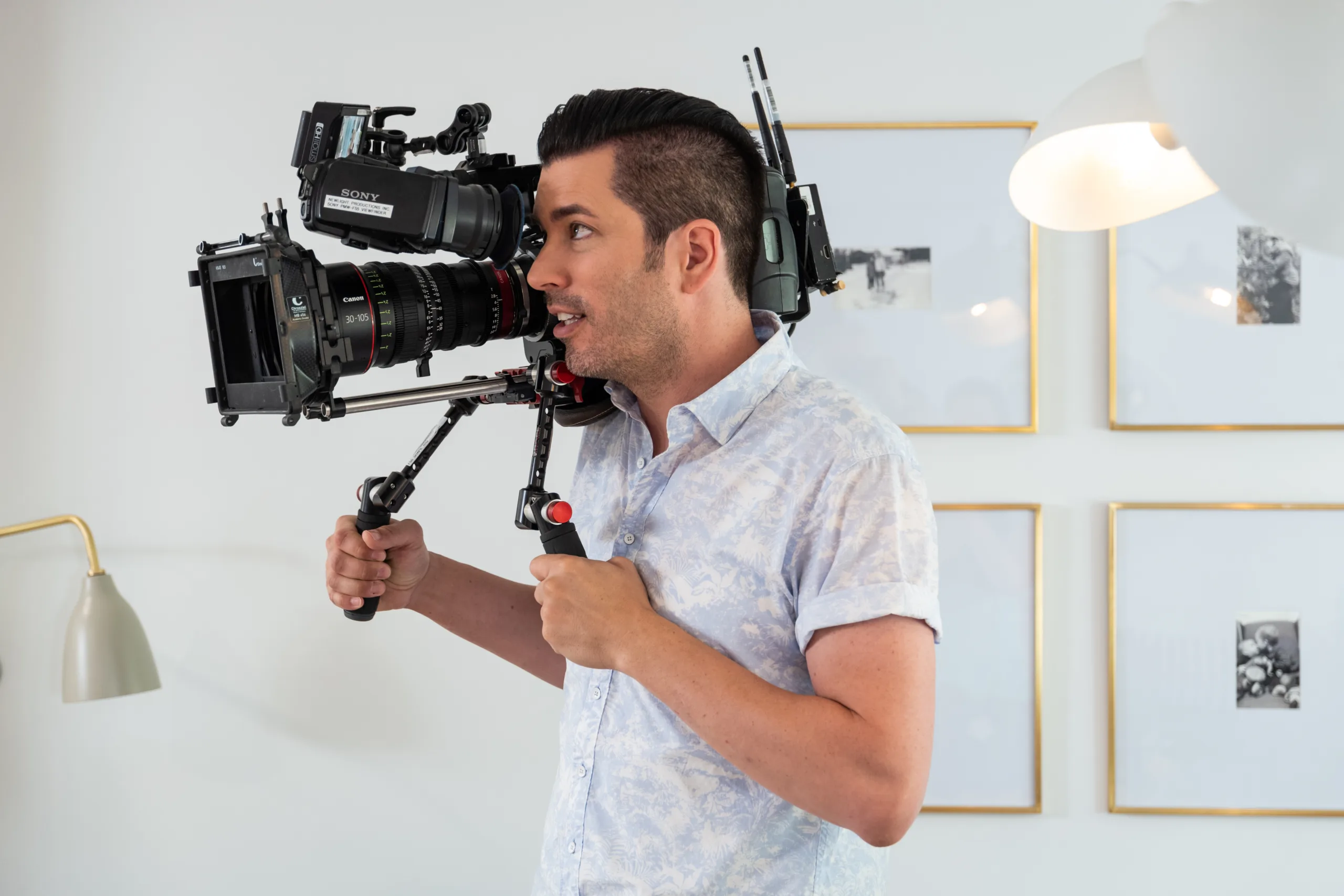 Jonathan Scott holds a video camera and shoots footage on the set of "Property Brothers."