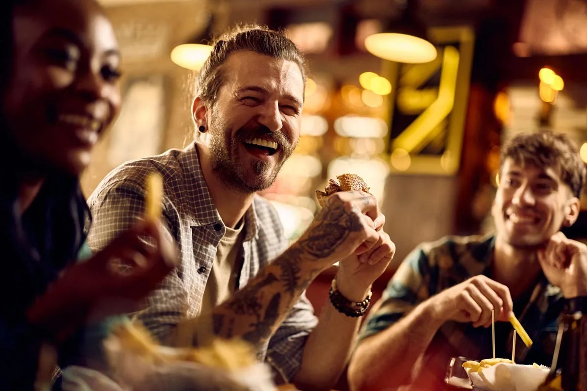 Friends enjoying their time together at a burger restaurant.