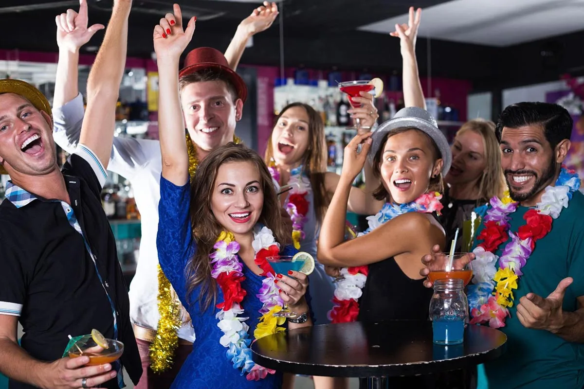Group of friends enjoying a theme night at a restaurant together.