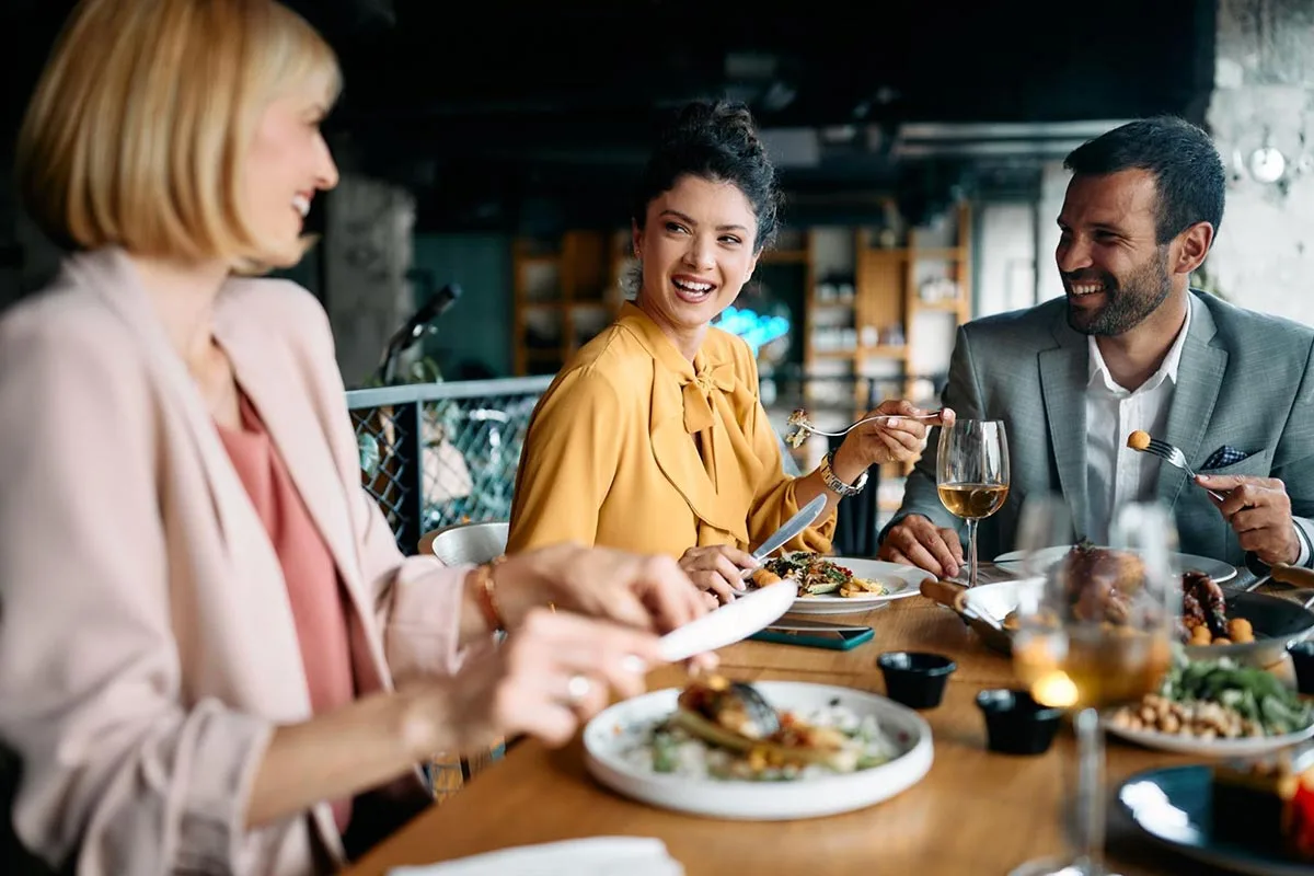 Work colleagues enjoying lunch together at a restaurant.