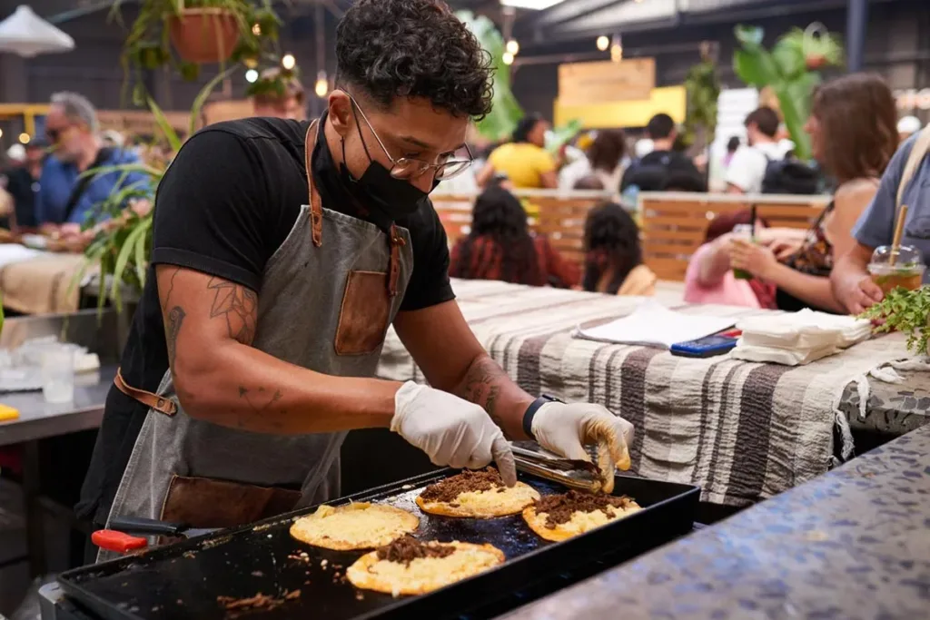 A chef preparing fresh tacos.